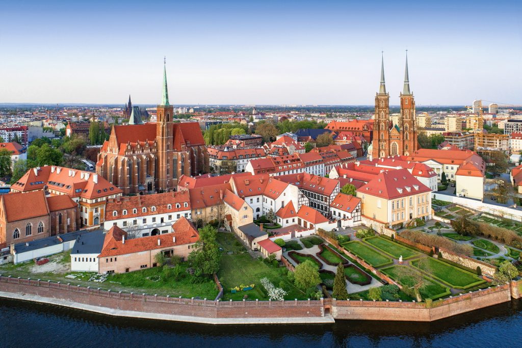 Poland. Wroclaw. Ostrow Tumski district with Gothic cathedral of St. John the Baptist,  Collegiate Church of the Holy Cross and St. Bartholomew and Odra (Oder) River. Aerial view in sunset light